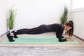 Workout at home.Athletic woman in sportswear doing stretching exercises at home in the living room. Royalty Free Stock Photo