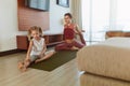 Workout At Home. Mother And Daughter Exercising Together In Living Room. Little Girl And Young Woman Practicing On Yoga Mat. Royalty Free Stock Photo