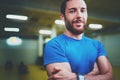 Workout indoor lifestyle concept.Portrait of young man athlete standing with crossed arms before training in fitness gym Royalty Free Stock Photo