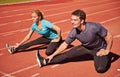 Workout, legs and couple stretching in stadium for race, marathon or competition training for health. Sports, energy and Royalty Free Stock Photo