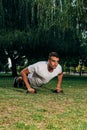 Push ups or press ups exercise by young man while working out on grass crossfit strength training Royalty Free Stock Photo