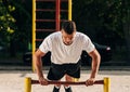 Push ups or press ups exercise by young man while working out on grass crossfit strength training Royalty Free Stock Photo