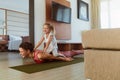 Workout. Mother And Daughter Exercising Together At Home. Happy Young Woman And Child Having Fun In Living Room. Royalty Free Stock Photo