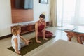 Workout. Mother And Kid Exercising At Home. Little Girl And Young Woman Practicing Together In Living Room. Royalty Free Stock Photo