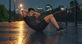 workout muscular man doing sit ups in rain Royalty Free Stock Photo