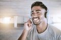 Workout music, fitness headphones or digital radio. Music technology device plays music, smiling relaxed indian man