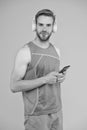 Workout phone for fitness fanatic. Fit guy listen to music on mobile phone. Using phone apps for sports training. Modern