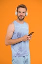 Workout phone for fitness fanatic. Fit guy listen to music on mobile phone. Using phone apps for sports training. Modern