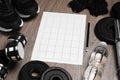 Workout plan, pencil and sports equipment on wooden table. Personal training Royalty Free Stock Photo