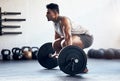 Workout, weightlifting and man doing deadlift training with strength, weights and motivation in fitness gym. Bodybuilder