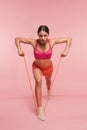 Workout. Woman Training With Resistance Bands On Pink Background Royalty Free Stock Photo