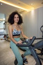 Young pretty woman on a exercycle Royalty Free Stock Photo