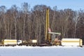 Workover rig working on a previously drilled well trying to restore oil production through repair. Russia