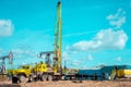 Workover rig working on a previously drilled well trying to restore production through repair. The pumping units and well workover