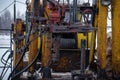 Workover rig working on a previously drilled well trying to restore production through repair. Toned