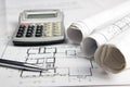 Workplace of architect - Architectural project, blueprints, rolls and calculator, pen on plans. Engineering tools view Royalty Free Stock Photo