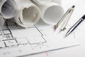 Workplace of architect - Architectural project, blueprints, rolls and tablet, pen, divider compass on plans. Engineering Royalty Free Stock Photo