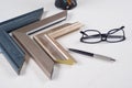Workplace of artist, decorator, designer with samples of baguettes, frames Royalty Free Stock Photo