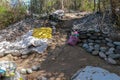 Workplace of Balinese stone gatherers. Sorted boulders by size. Natural building material. Hard work. Stones thrown from the sea a