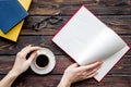 Workplace with book in hands for reading, glasses, coffee on wooden background flatlay mockup Royalty Free Stock Photo