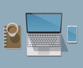 Workplace of a businessman, programmer, designer or freelancer with a laptop, workbook, smartphone and a cup of coffee