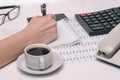 Workplace with calculator, notepad and documents. Workflow of a company employee. Budget planning and tax reporting. Royalty Free Stock Photo