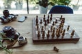Workplace concept with old retro cameras, smartphone and chess board Royalty Free Stock Photo