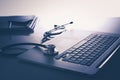 Workplace of doctor with laptop and stethoscope and notebook on white table