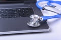 Workplace of doctor with laptop, stethoscope, RX prescription, glasses and notebook on white table. Copy space. Royalty Free Stock Photo