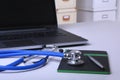 Workplace of doctor with laptop, stethoscope, RX prescription, glasses and notebook on white table. Copy space. Royalty Free Stock Photo