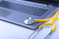 Workplace of doctor with laptop, stethoscope and RX prescription on white table. top view. Royalty Free Stock Photo