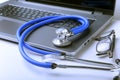 Workplace of doctor with laptop, stethoscope and RX prescription on white table. top view. Royalty Free Stock Photo