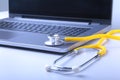 Workplace of doctor with laptop, stethoscope and RX prescription on white table. top view. Royalty Free Stock Photo