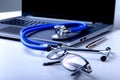 Workplace of doctor with laptop, stethoscope and RX prescription on white table. top view. Royalty Free Stock Photo