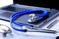 Workplace of doctor with laptop, stethoscope and RX prescription on white table. top view. Royalty Free Stock Photo