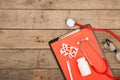 Workplace of doctor. Stethoscope, clipboard, glasses and pills on wooden desk Royalty Free Stock Photo