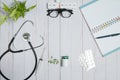 Doctor table with medical items, stethoscope and pills Royalty Free Stock Photo