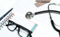 Doctor table with medical items, stethoscope and pills Royalty Free Stock Photo