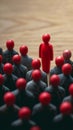 Workplace dynamics red doll amid others symbolizes discussions or leadership Royalty Free Stock Photo