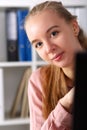 Workplace girl peeks out from behind monitor