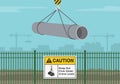 Workplace golden safety rules and tips. Caution, keep out from under crane loads. Construction area warning sign on a green fence. Royalty Free Stock Photo