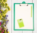 Workplace with green clipboard, blank yellow paper, calculator, Royalty Free Stock Photo