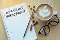 Workplace harassment concept on notebook with glasses, pencil an