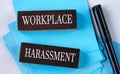 WORKPLACE HARASSMENT - words on wooden brown blocks on a light background with a marker Royalty Free Stock Photo
