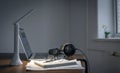 Workplace with headphones and laptop in the evening, copy space. Royalty Free Stock Photo