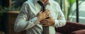 Workplace health Asian man endures chest pain, indicative of heart issues Royalty Free Stock Photo