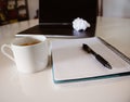 Workplace at home. Laptop, crumpled paper, notebook, pen, coffee Royalty Free Stock Photo
