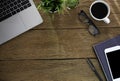 Workplace at home with wood table. Top view from above of laptop with notebook and coffee. Office space for modern creative work o Royalty Free Stock Photo