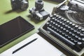 Workplace Of A Journalist, Writer, Blogger. Analog Typewriter, Digital Tablet And Film Camera On The Green Table Royalty Free Stock Photo