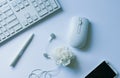 Workplace - keyboard, computer mouse, chemical, headset, white telephone.